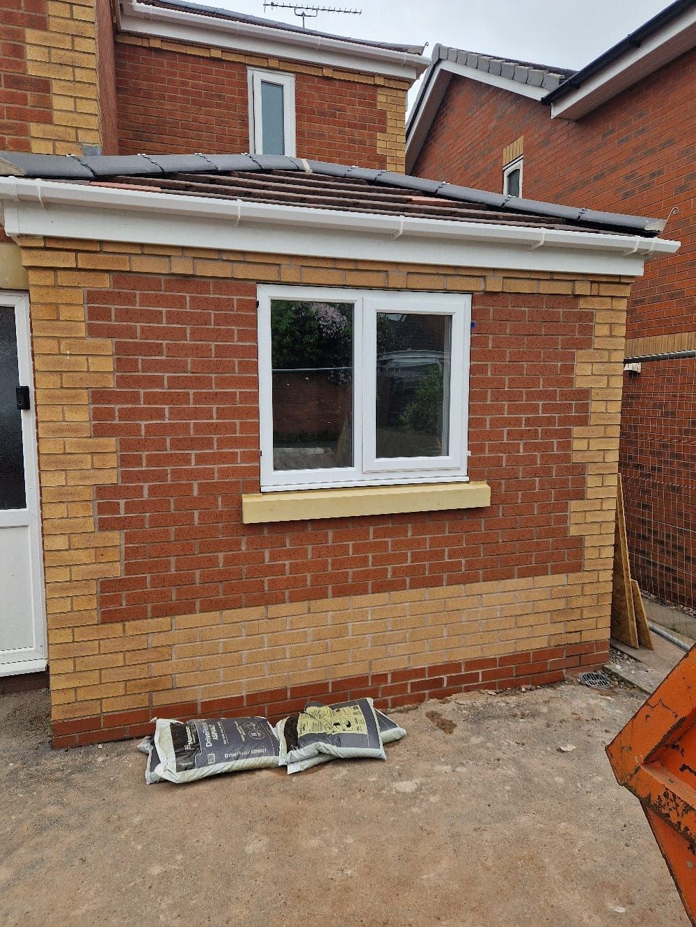 In-progress facing brickwork around a new window opening on a King's Lynn extension | bricklaying in King's Lynn by Humphries Construction