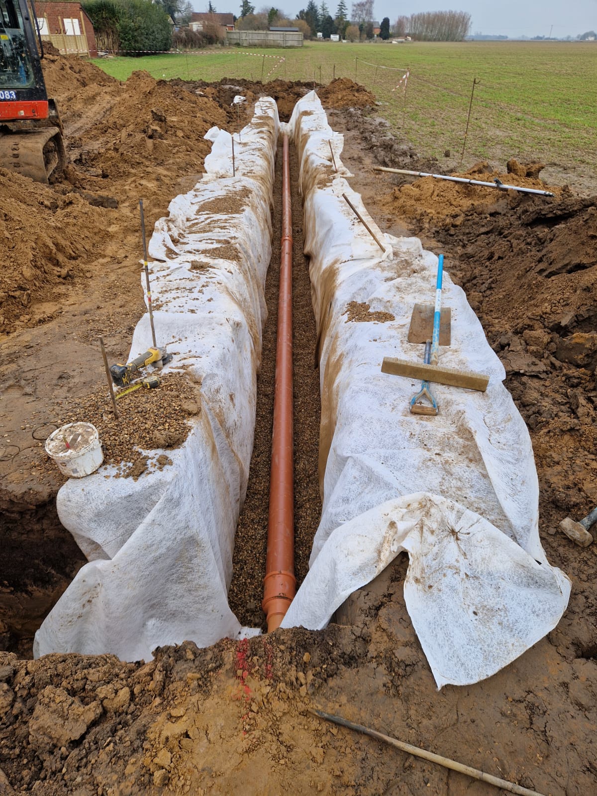 New drainage pipe run laid in a trench across a Norfolk site | groundworks and drainage in King's Lynn by Humphries Construction